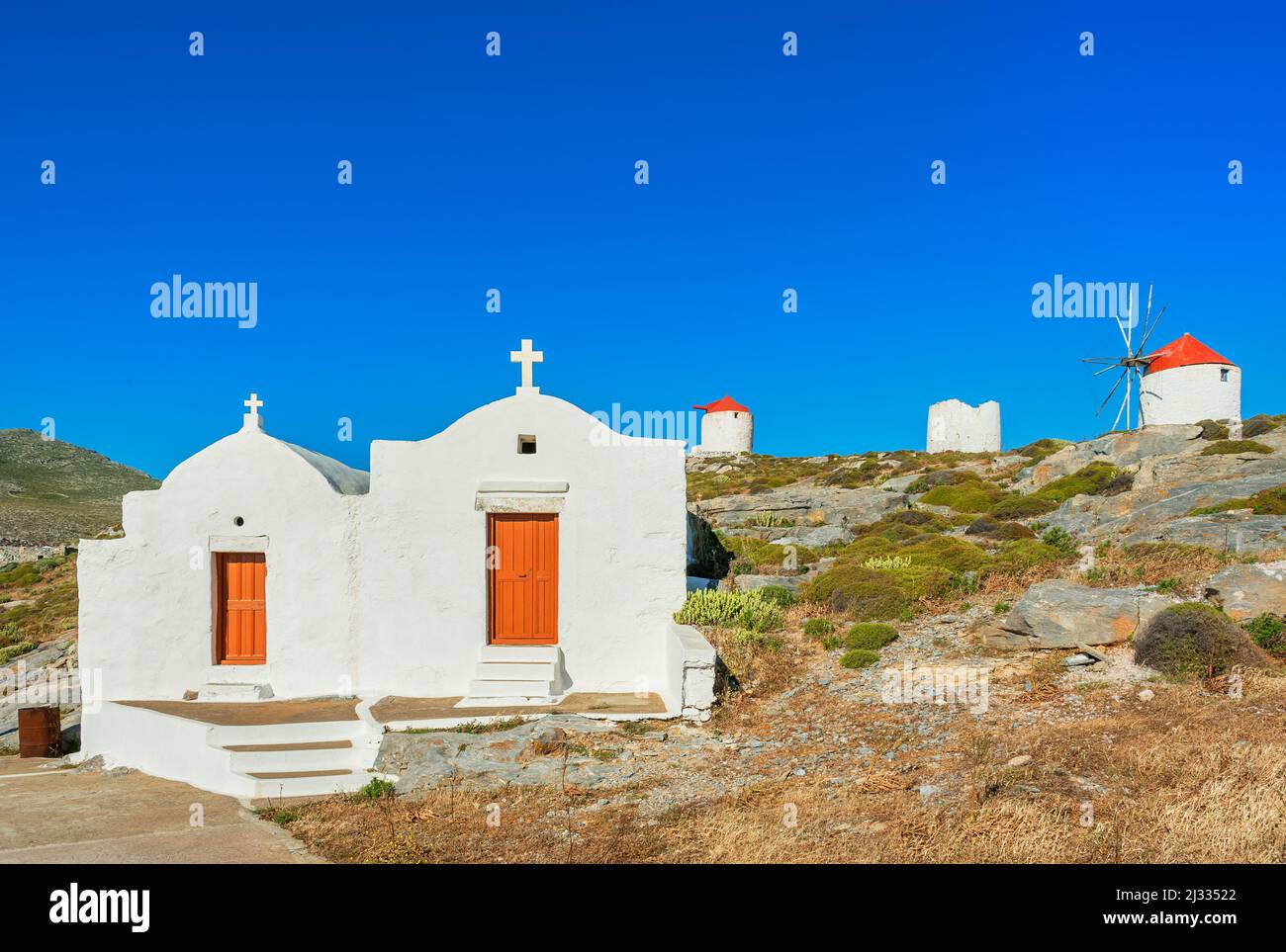 View of Orthodox chapel and traditional windmills, Chora, Amorgos, Cyclades Islands, Greece Stock Photo