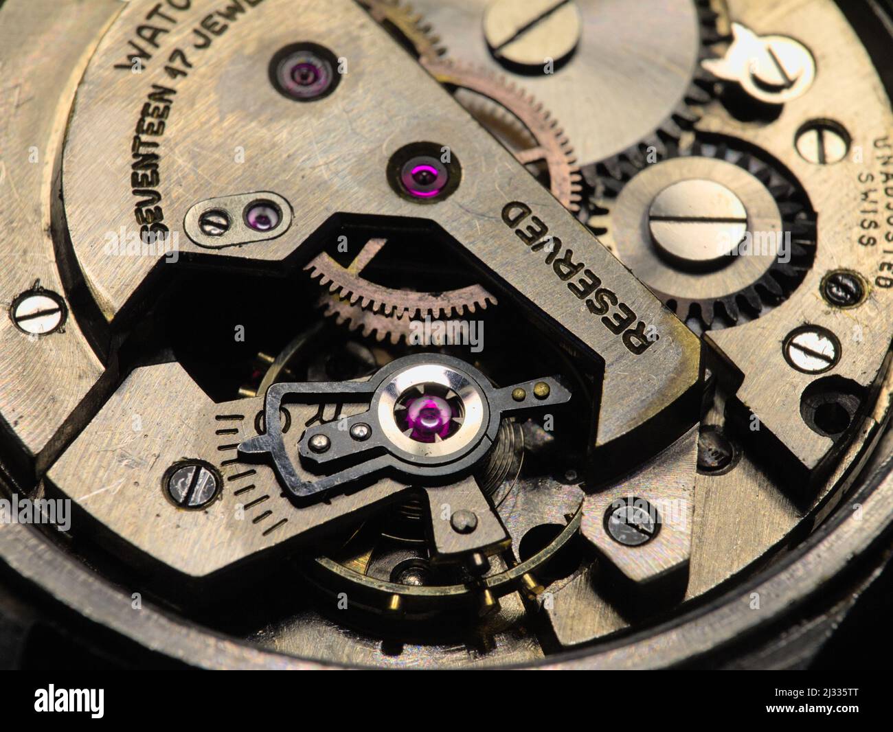 Mechanism of old mechanical watches with a pendulum, gears and other details. Selective focus. Stock Photo