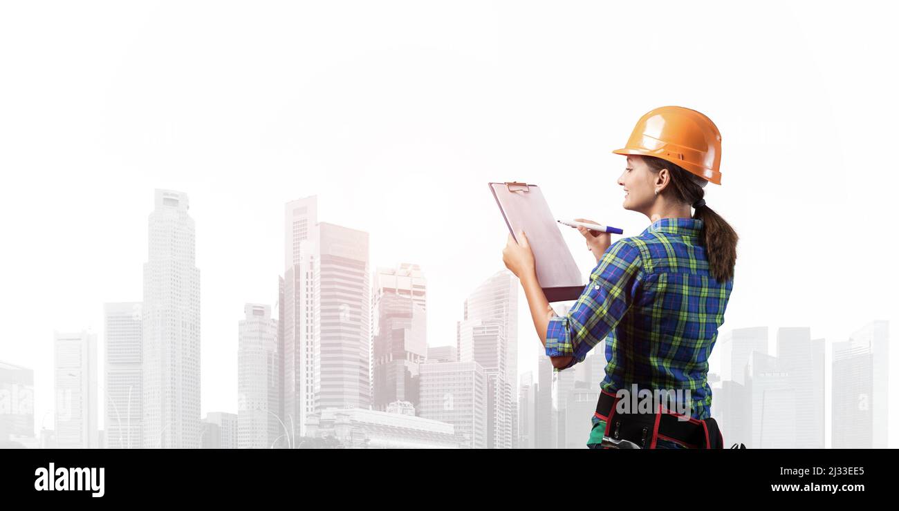 Young building controller with clipboard Stock Photo - Alamy