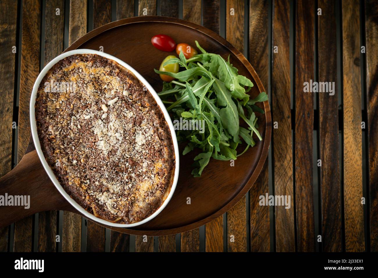 fresh beef lasagna in traditional oven dish on table in rome italy restaurant Stock Photo