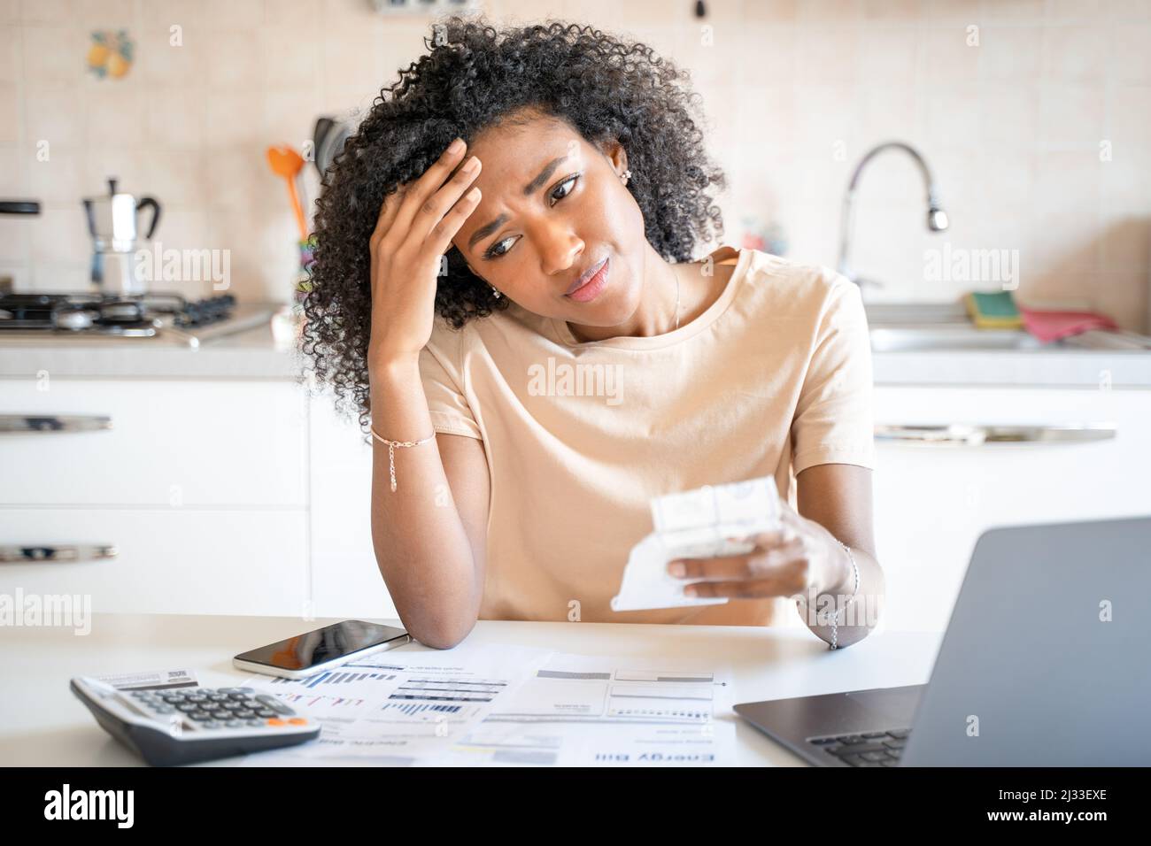 One black woman worried about home expenses Stock Photo
