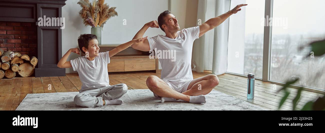 Fun During Training Jolly man having fun during training with son Stock Photo - Alamy