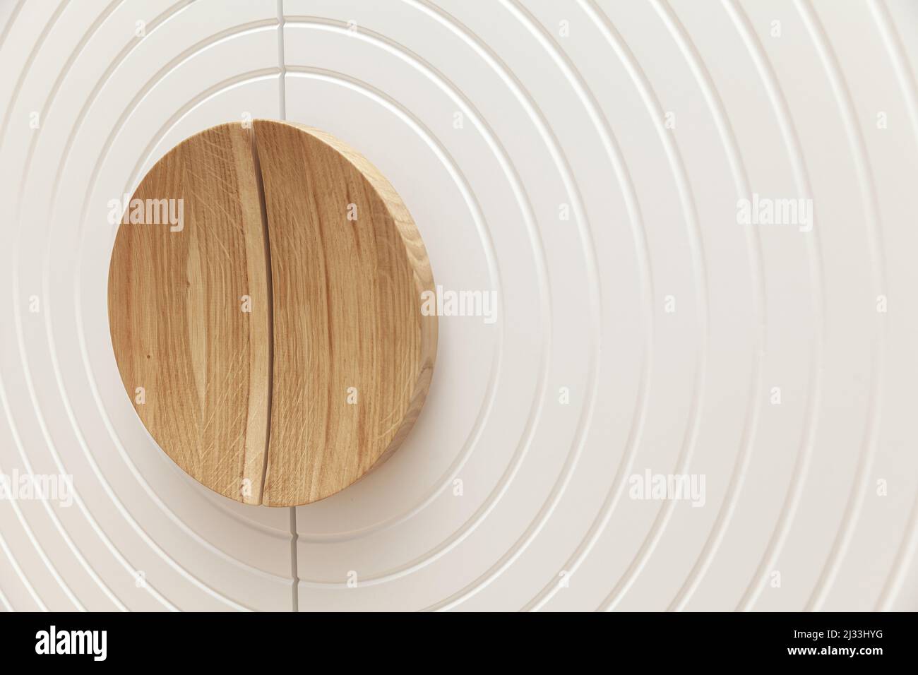 circular wooden handles on the white door, close up Stock Photo