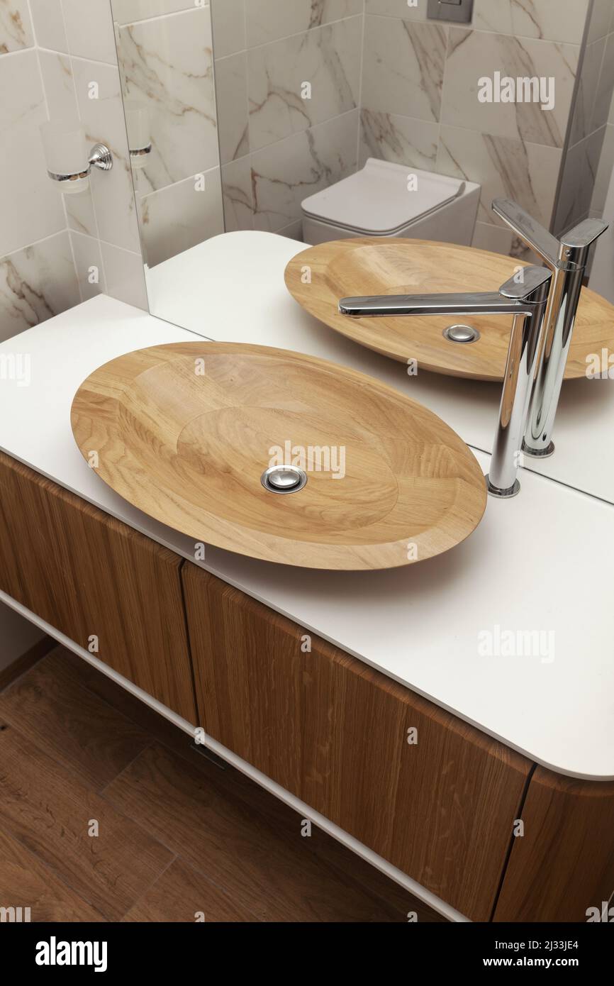 sink made of wood in the bathroom, close up Stock Photo