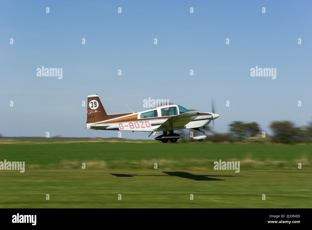 Gulfstream American AA-5B Tiger G-BOZO taking off to race at a round of the Royal Aero Club Air Race at Great Oakley airfield in rural Essex, UK Stock Photo