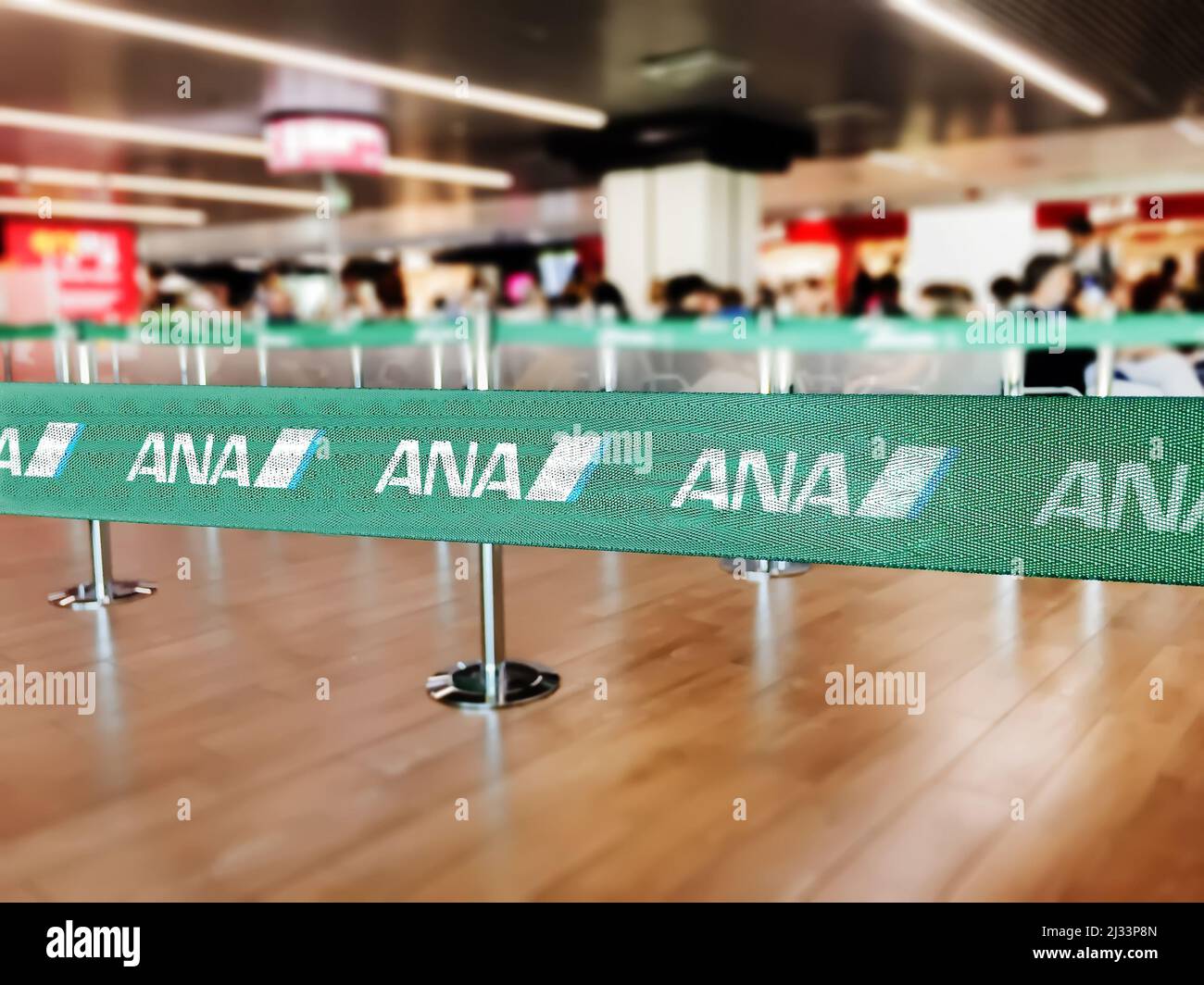 London, UK, July 2019: Green belt barrier with white ANA All Nippon Airways logo. ANA All Nippon Airways is a japan airline. Travel and airport securi Stock Photo