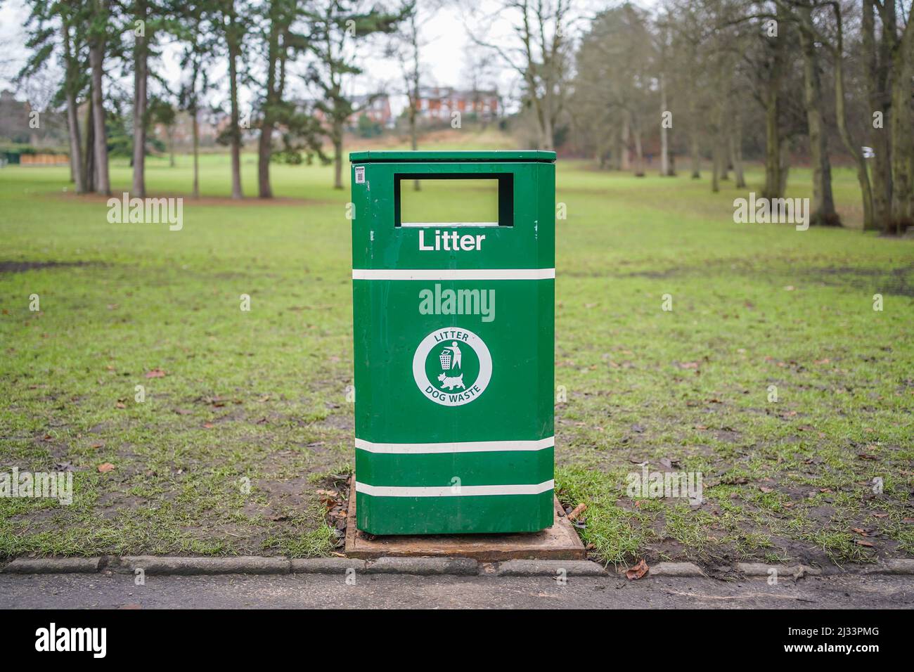 Close up of a green dog waste litter bin isolated in a UK country park