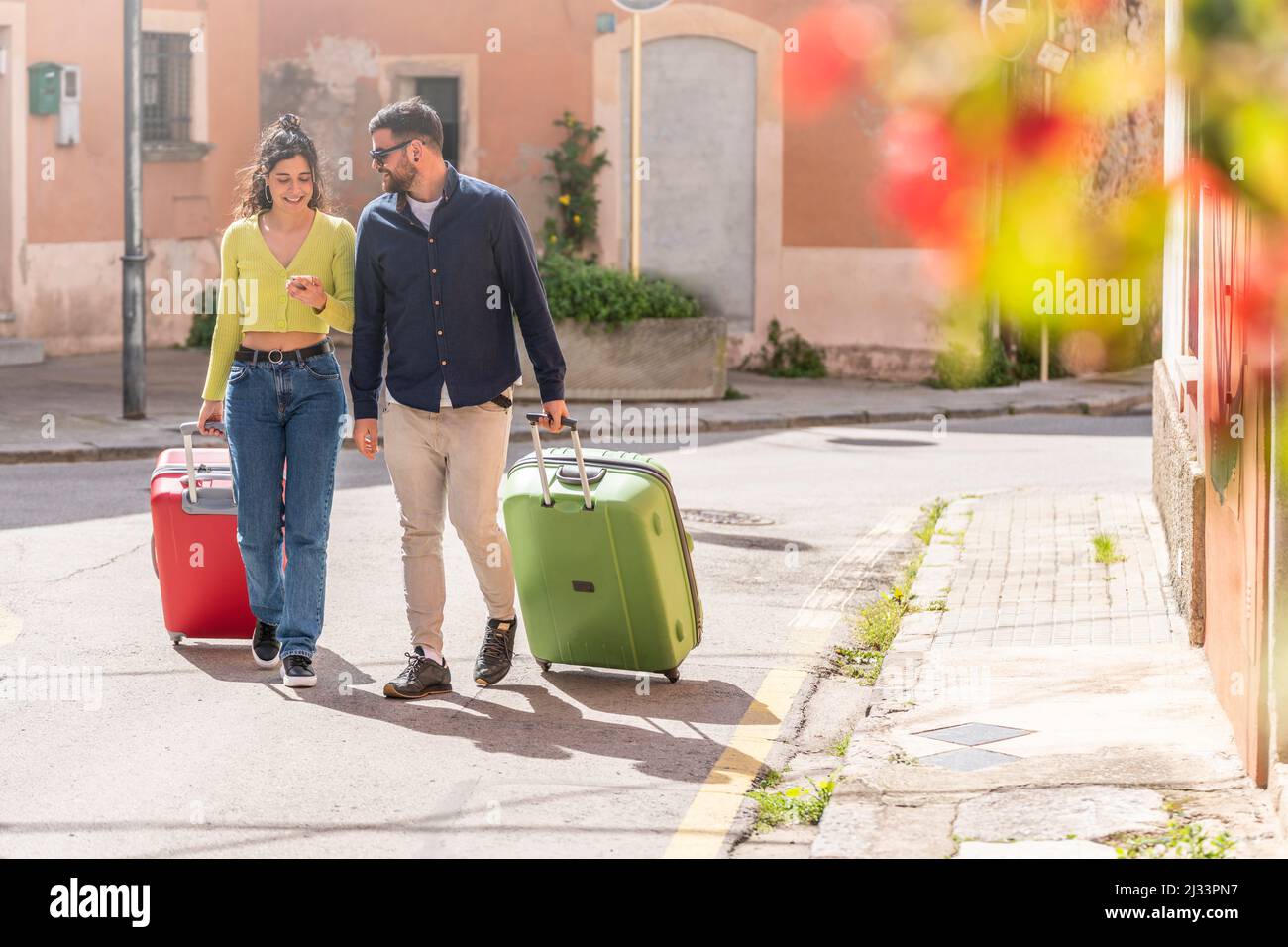 Tourist couple walking down the street looking for their hotel Stock Photo