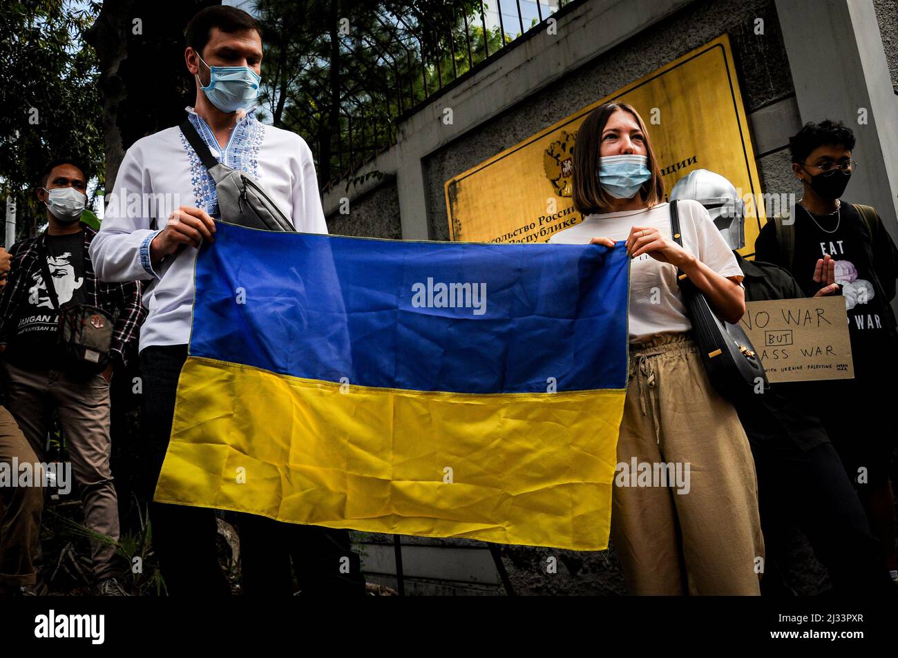 Ukrainian citizens in Indonesia hold the Ukrainian flag during a peaceful protest in Jakarta, Indonesia on March 4, 2022. Stock Photo