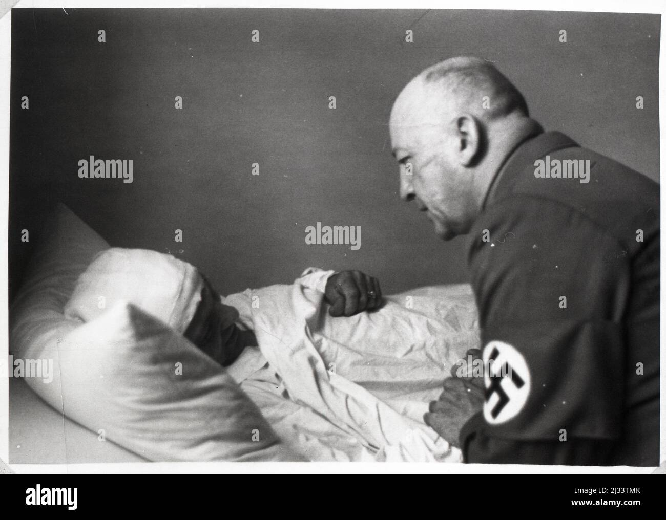 Gauleiter Wagner besucht die opfer des Attentats vom 9.11.1939 -  Official Wagner visits a victim of the assassination attempt on Nov. 9, 1939. Eva Braun's Photo Albums, ca. 1913 - ca. 1944. These albums are attributed to Eva Braun (four are claimed by her friend Herta Schneider, nee Ostermeyer) and document her life from ca. 1913 to 1944. There are many photographs of Eva, her sisters and their children, Herta Schneider and her children, as well as photographs of Eva's vacations, family members and friends. Included also are photographs taken by and of Eva Braun at Hitler's chalet Berghof (or Stock Photo