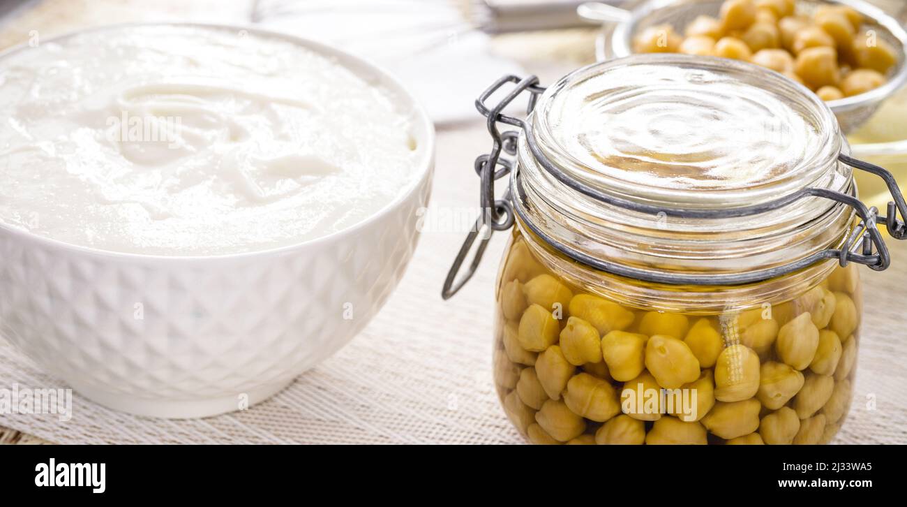 Cooked chickpeas alongside eggfree substitute ingredient, egg whites