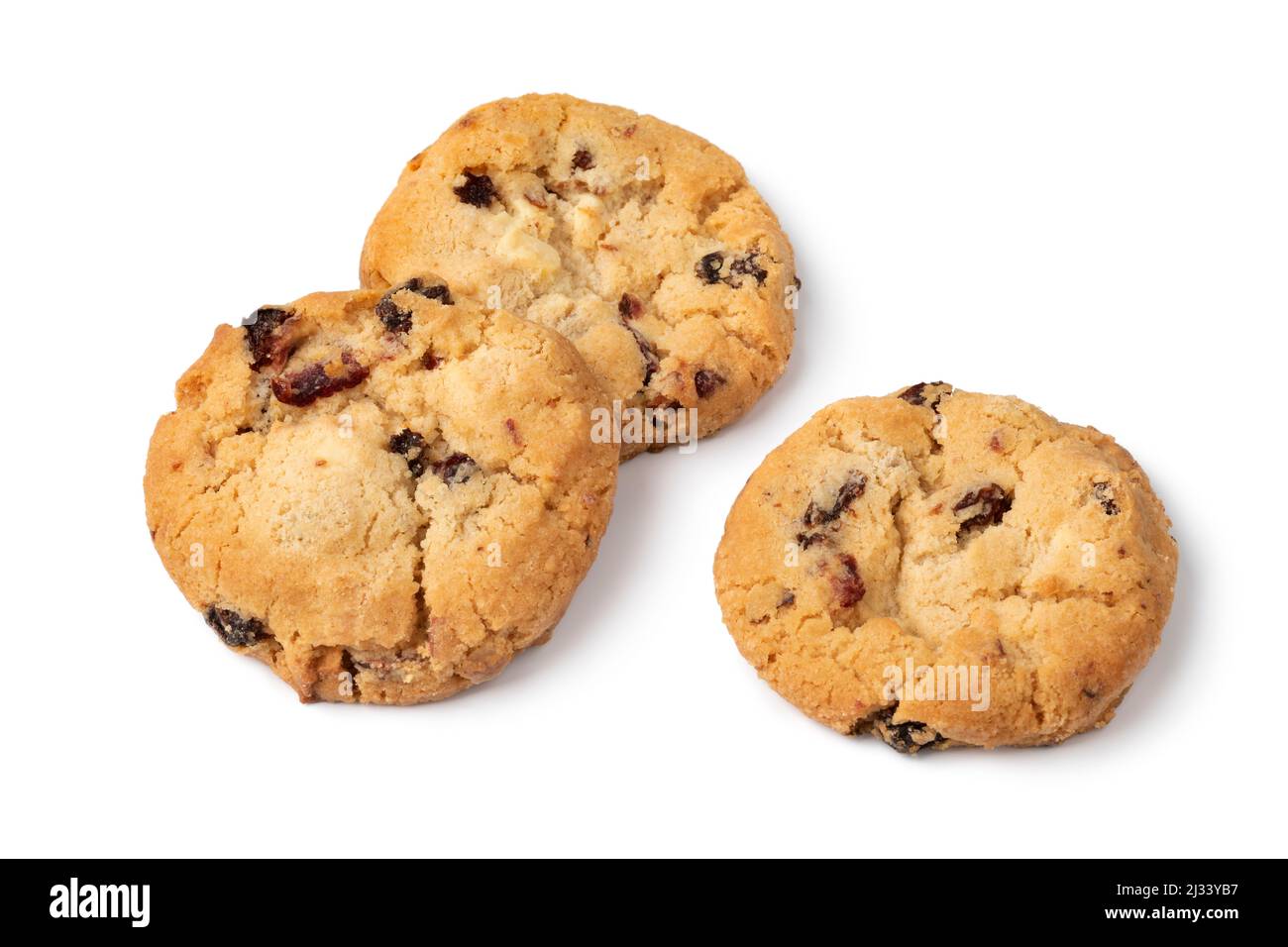 Heap of fresh baked chocolate cranberry cookie close up isolated on white background Stock Photo