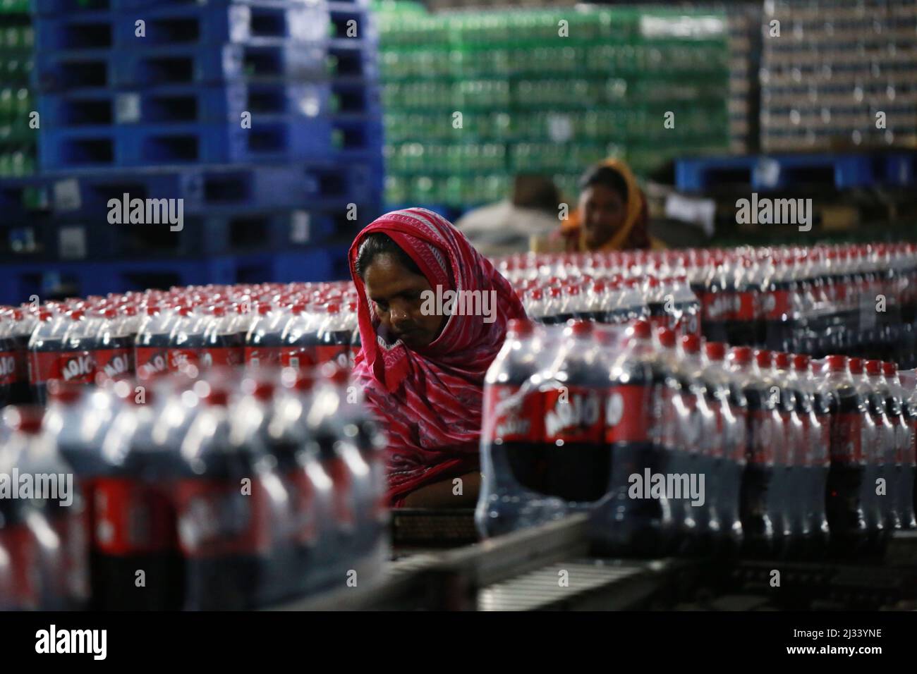 Plastic bottles of soft drink are seen on an assembly line at a beverage factory in Dhaka, Bangladesh January 5, 2020. Bangladesh’s GDP is expected to grow by 4.5 percent in fiscal year 2020 and 7.5 percent in fiscal year 2021, according to the Asian Development Bank (ADB) report of Asian Development Outlook (ADO) 2020. Stock Photo