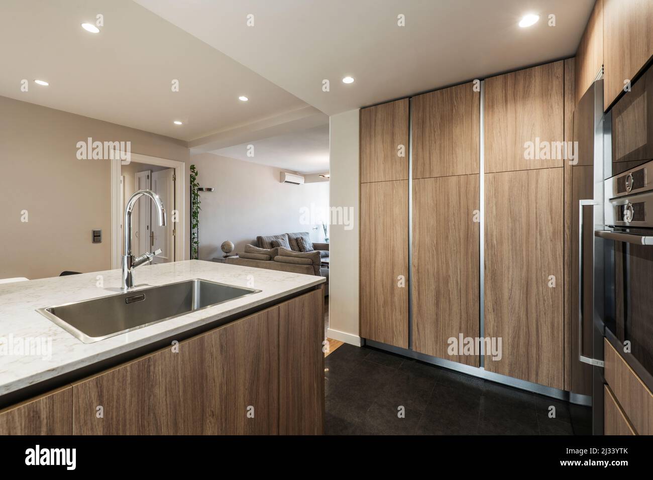 Kitchen with wall to wall oak furniture, stainless steel appliances and ...