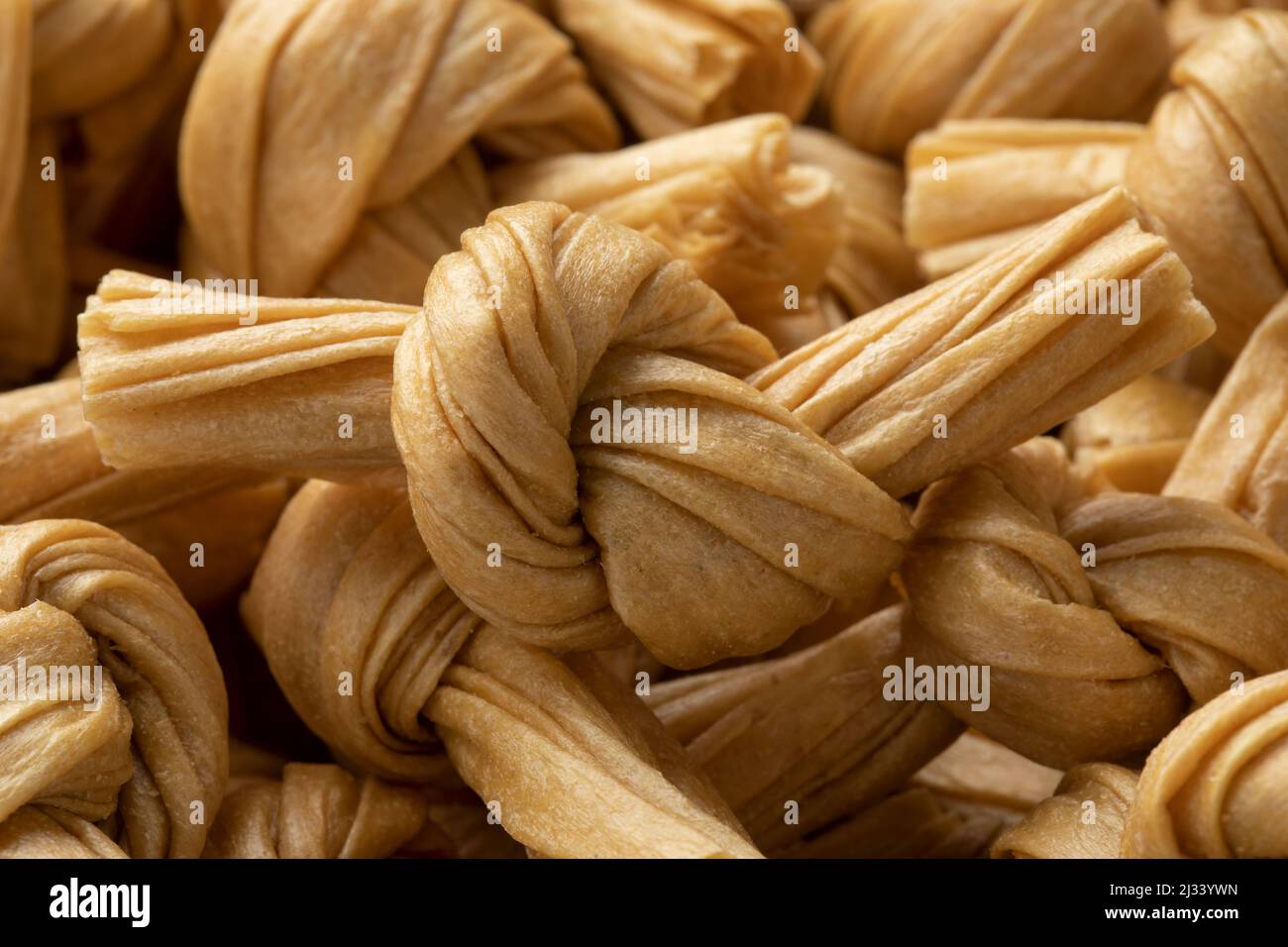 Uncooked bean curd knot full frame close up as background Stock Photo