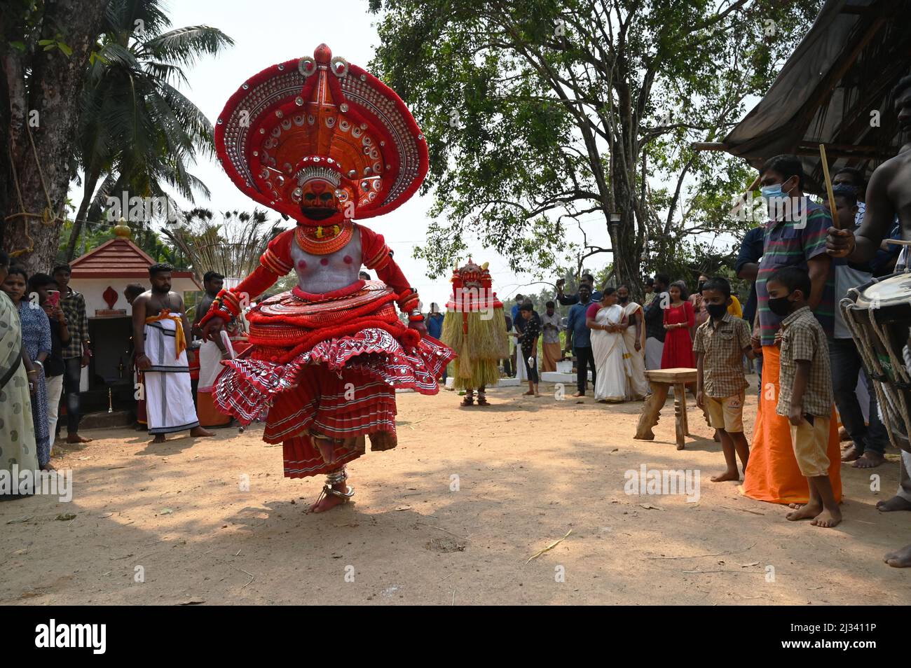 Theyyam is a popular ritual form of dance worship in Kerala and Karnataka.Theyyam consists of thousand year-old traditions,rituals and customs Stock Photo