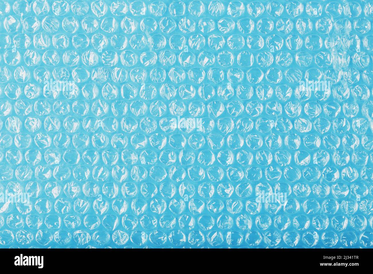 Packing bubble wrap for parcels on a blue background in full screen Stock Photo