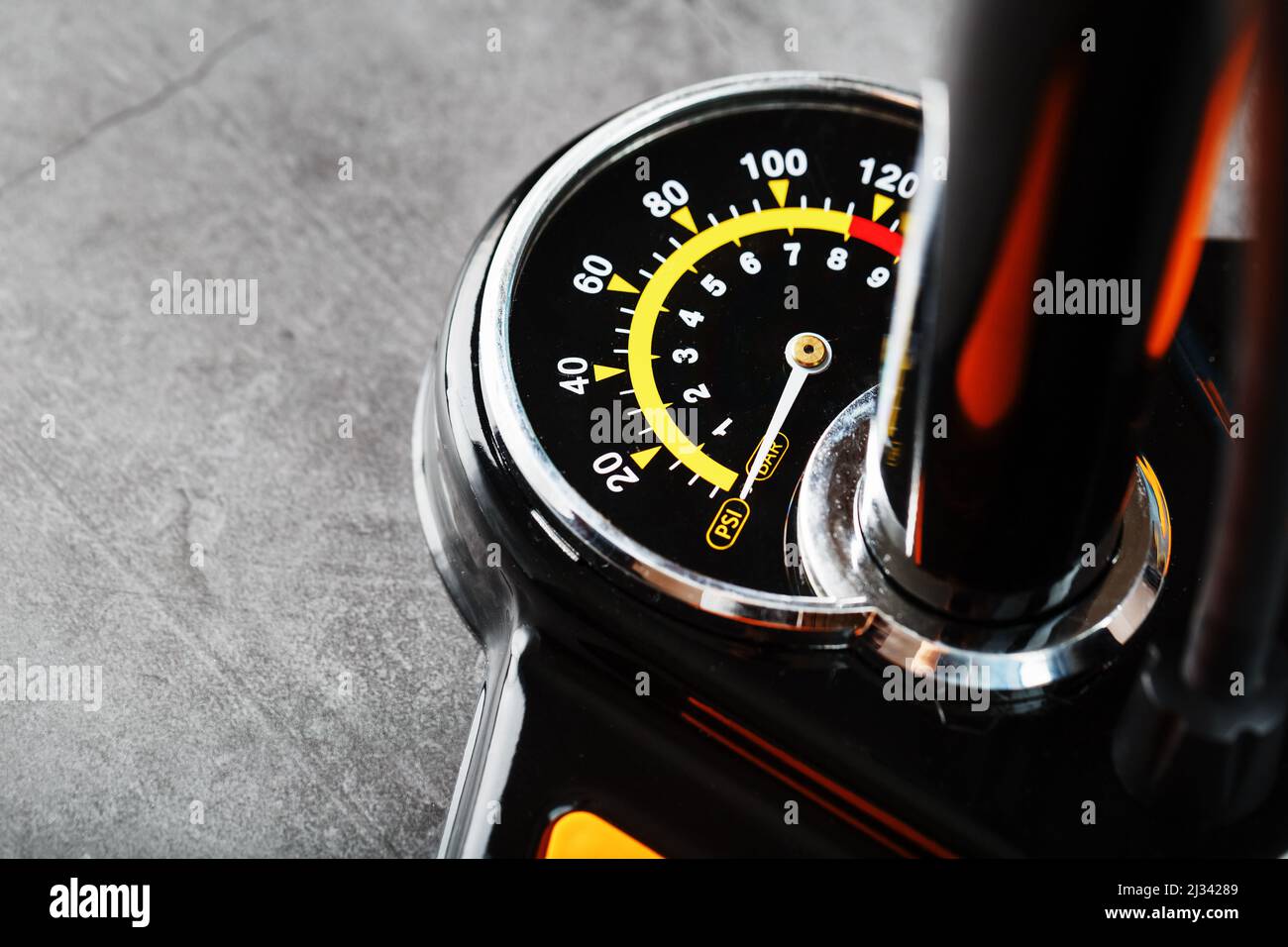 Air pump manometer for monitoring tire pressure on a dark background with free space Stock Photo