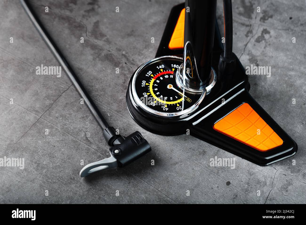 Air pump manometer for monitoring tire pressure on a dark background with free space Stock Photo