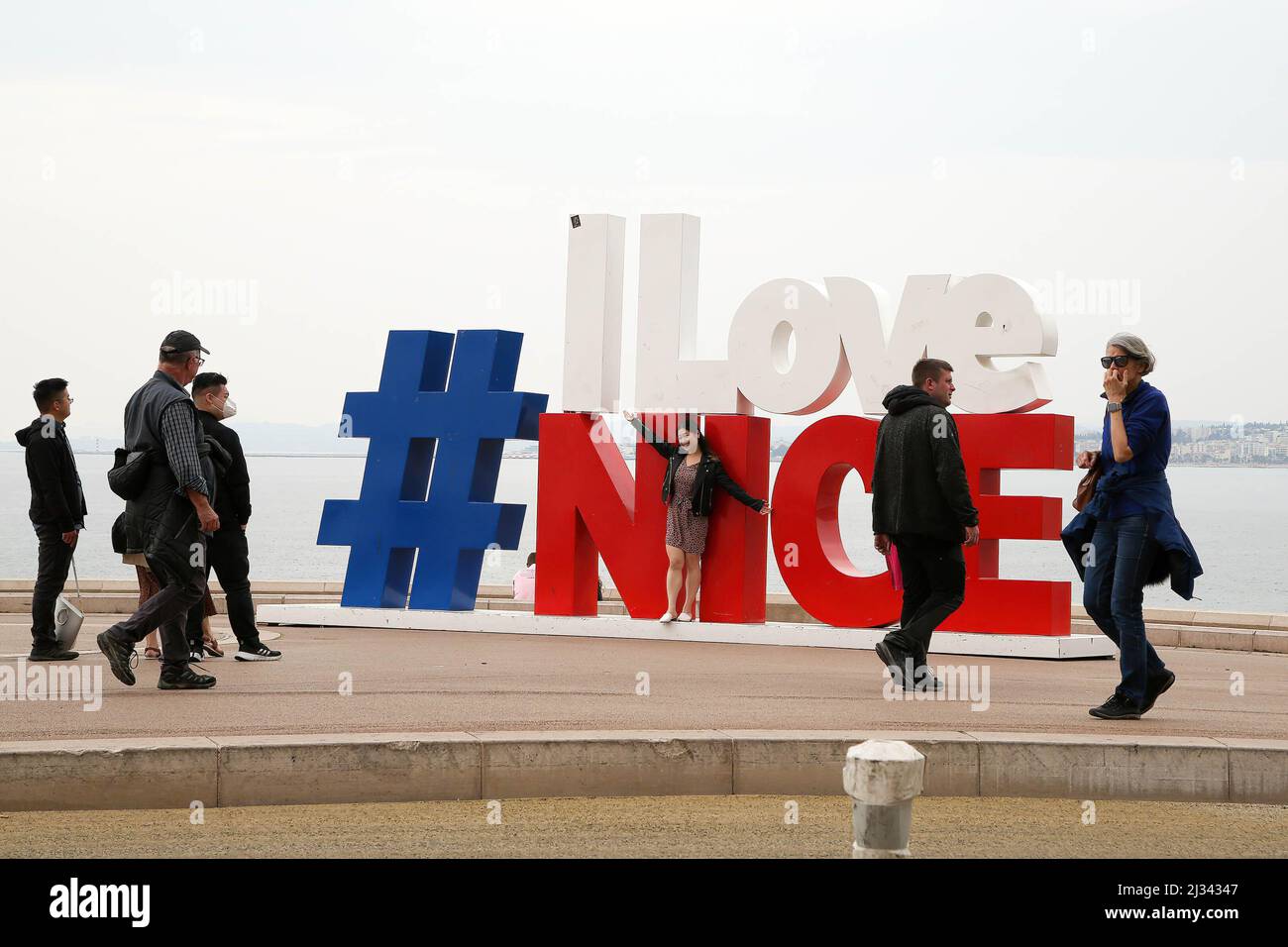 Nice, France. 27th Mar, 2022. Tourists seen next to 'I LOVE NICE' sculpture  overlooking the Promenade des Anglais, the most popular tourist attraction.  Nice is located on the French Riviera, the southeastern