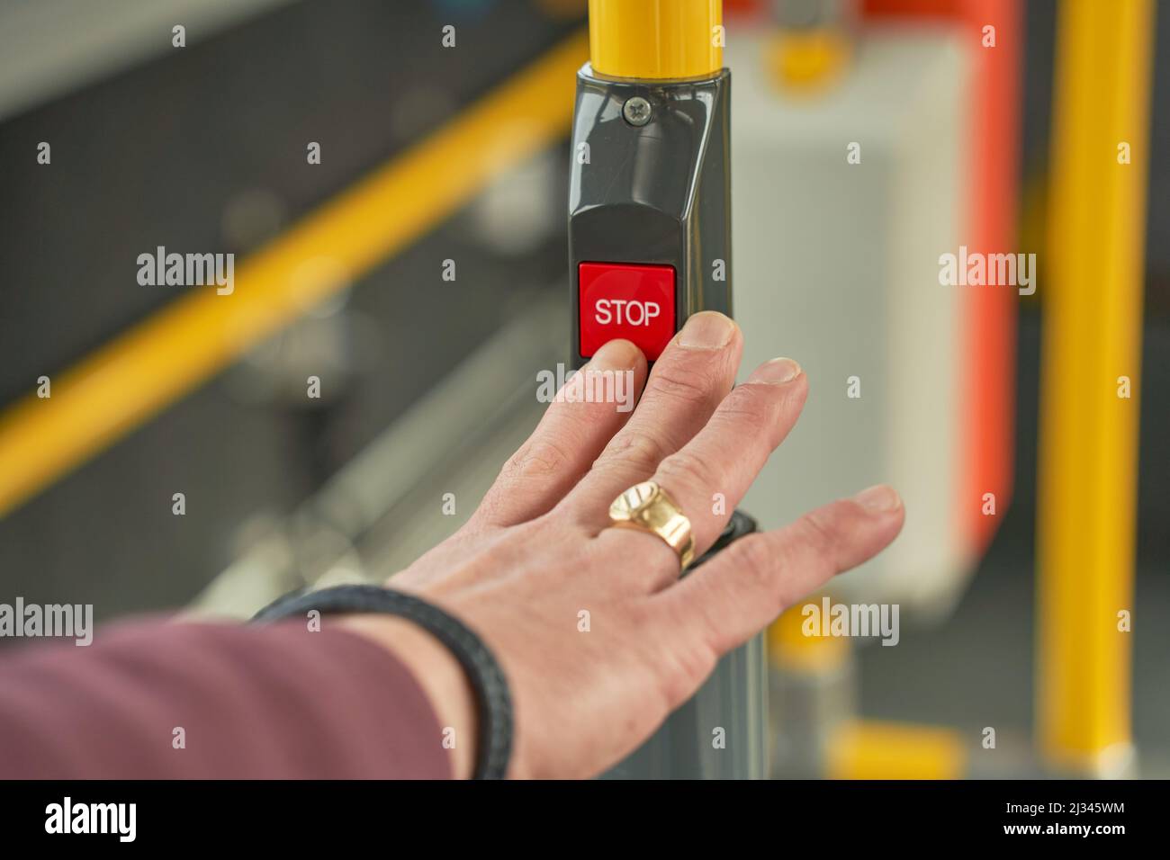 A male hand pushing a bus stop button inside of bus Stock Photo - Alamy