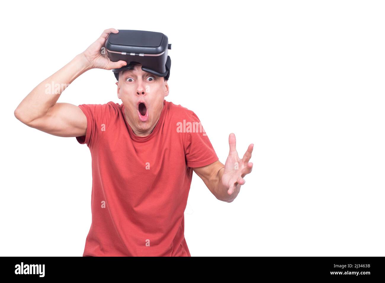 Shocked man in VR headset looking at camera Stock Photo