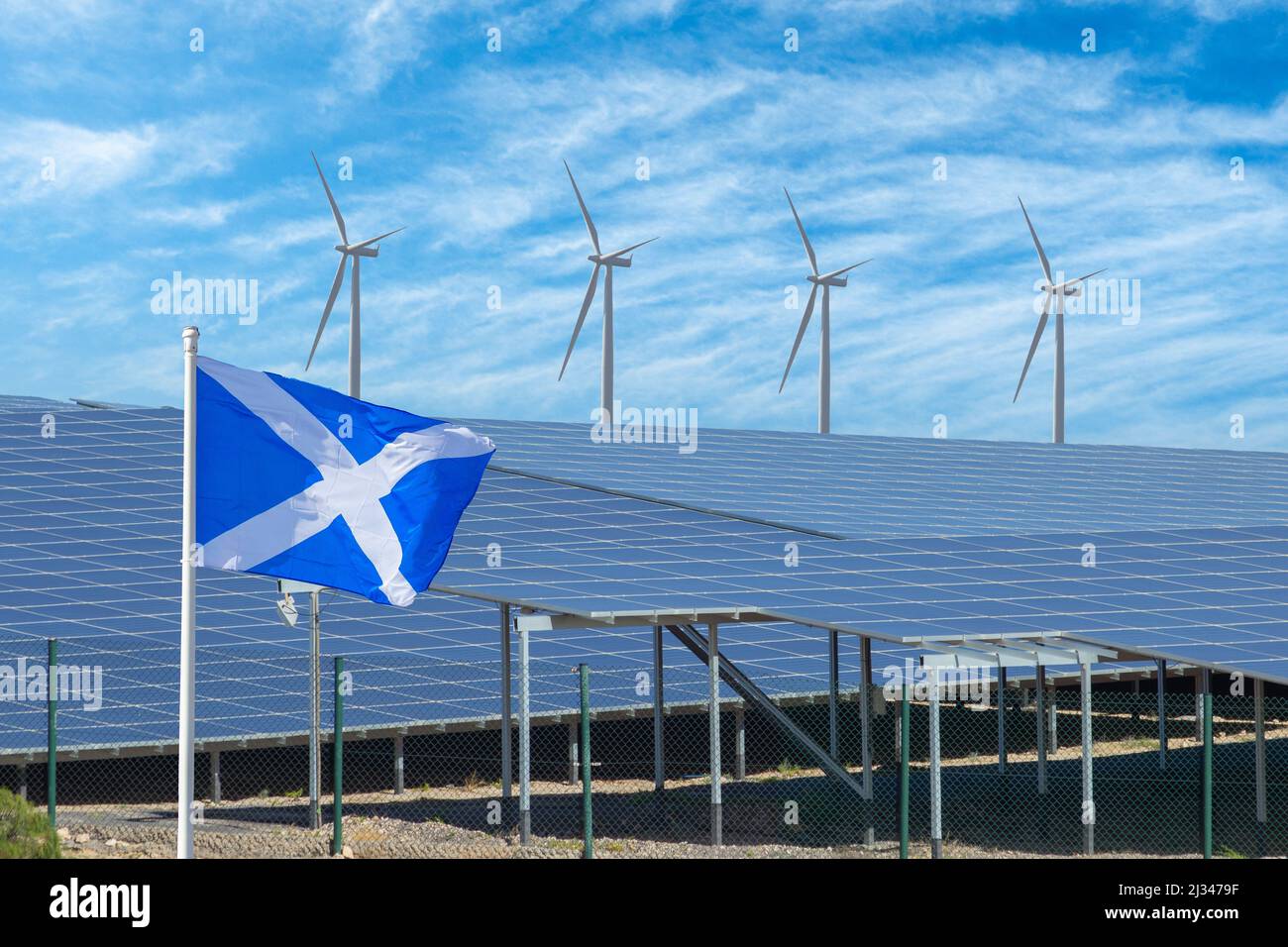 Flag of Scotland, solar panels, onshore wind turbines. Clean, cheap renewable energy, net zero emissions, electricity, cost of living, crisis concept Stock Photo