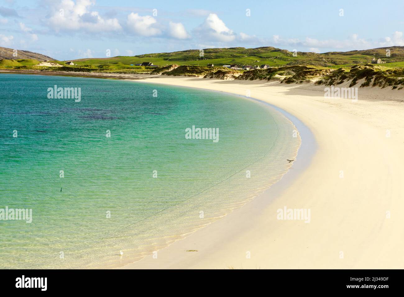 white sandy Vatersay beach, causeway, grass dunes, Isle of Barra, Outer Hebrides, Scotland UK Stock Photo
