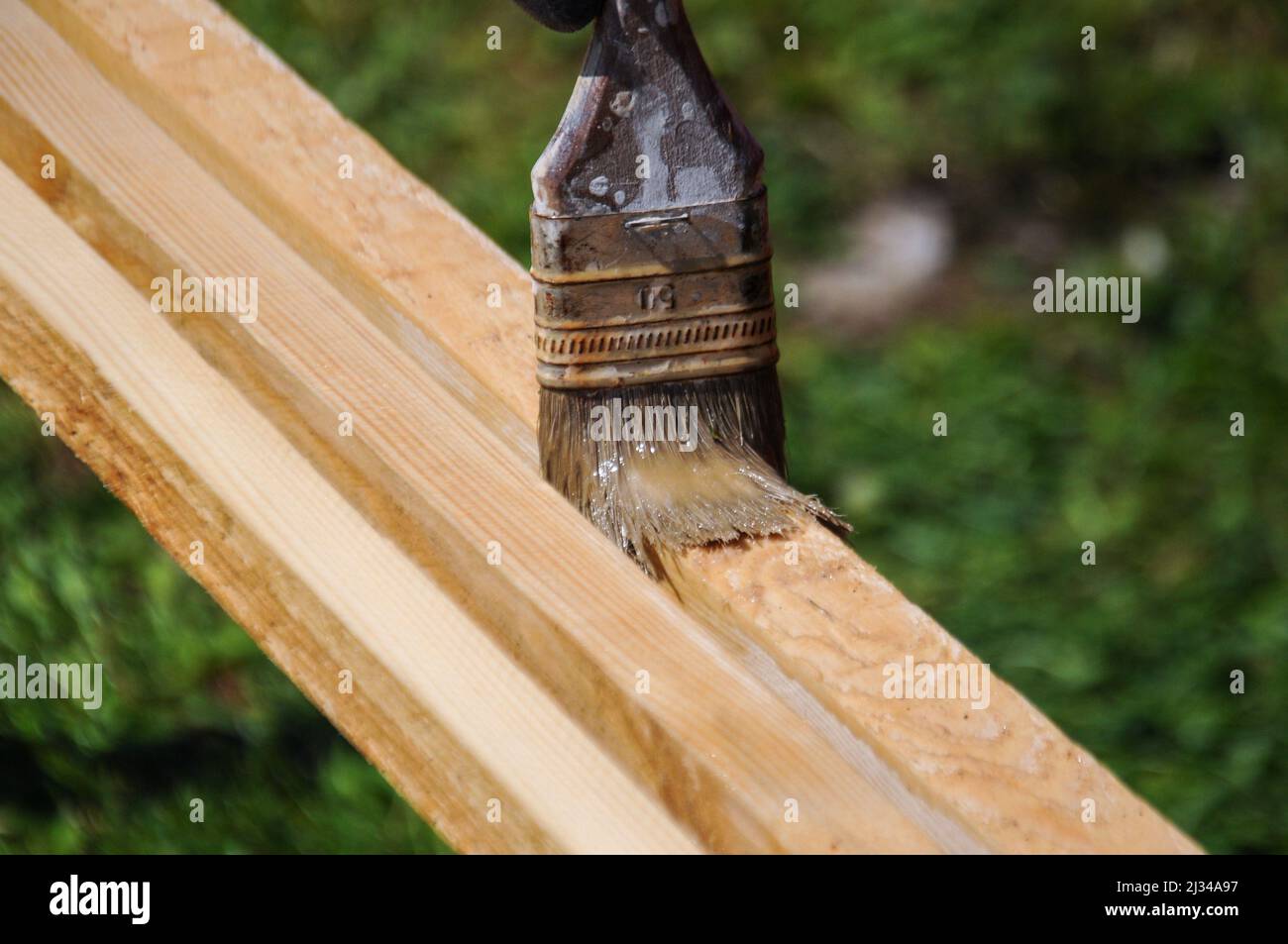 Hand painting the wooden board with a brush outdoor Stock Photo Alamy