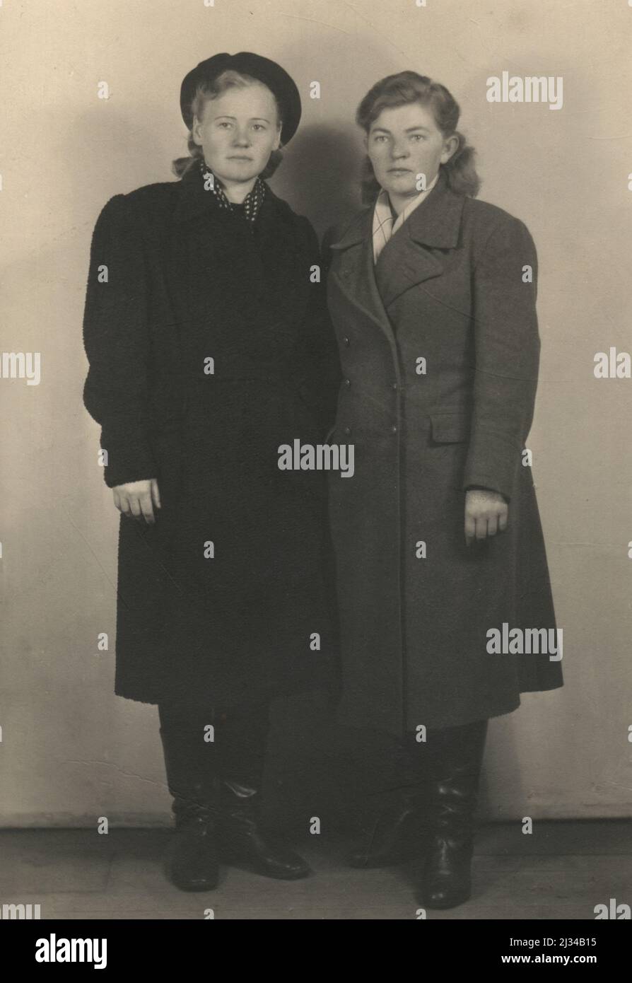 Vintage photograph. Full-length portrait of  two women in outer clothing, USSR, 1945-1949 Stock Photo