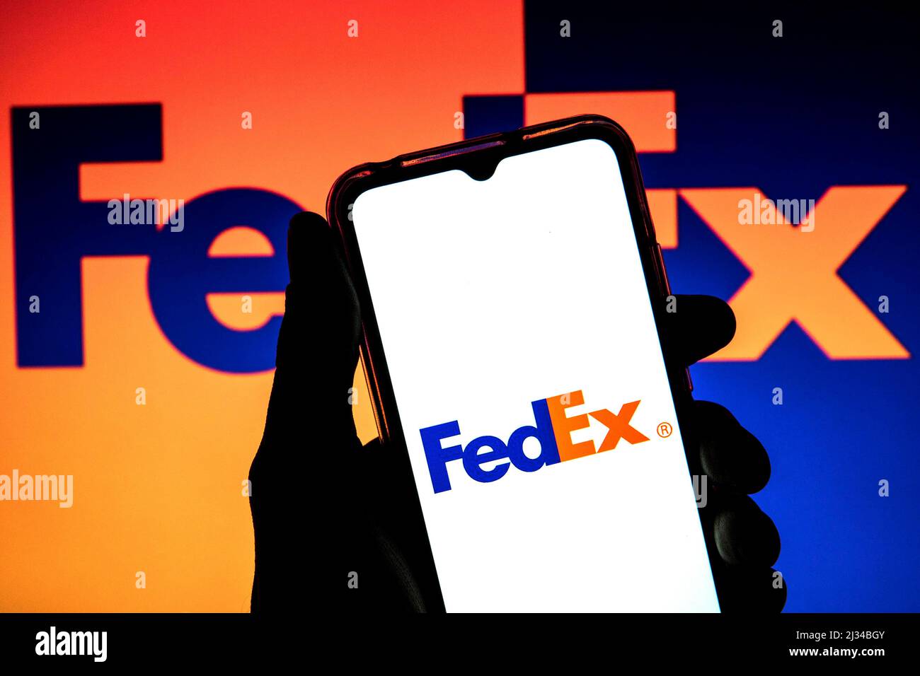 Spain. 4th Apr, 2022. In this photo illustration a FedEx Corporation logo seen displayed on a smartphone with a FedEx Corporation logo in the background. (Credit Image: © Thiago Prudencio/SOPA Images via ZUMA Press Wire) Stock Photo