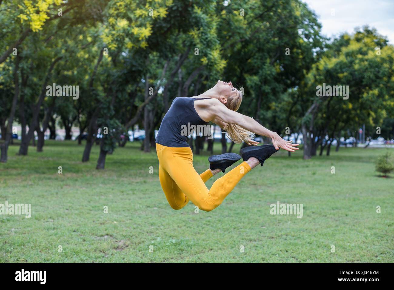 Young woman jumping high hi-res stock photography and images - Alamy