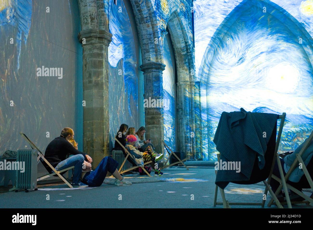 People watching the immersive experience of the Van Goch in Leicester where heaters and blankets are provided while viewers sit in deckchairs Stock Photo