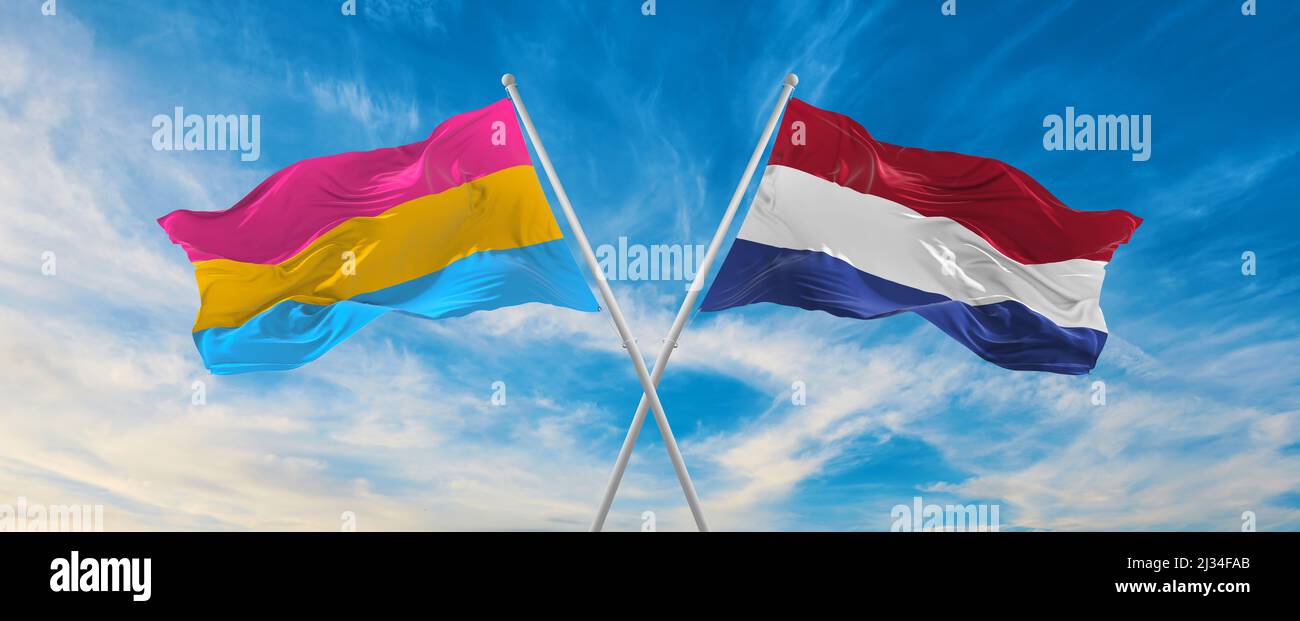 two crossed flags Pansexuality Pride and Netherland waving in wind at ...