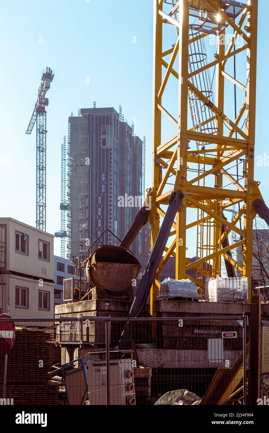 Building with high tower cranes and tall buildings Stock Photo - Alamy