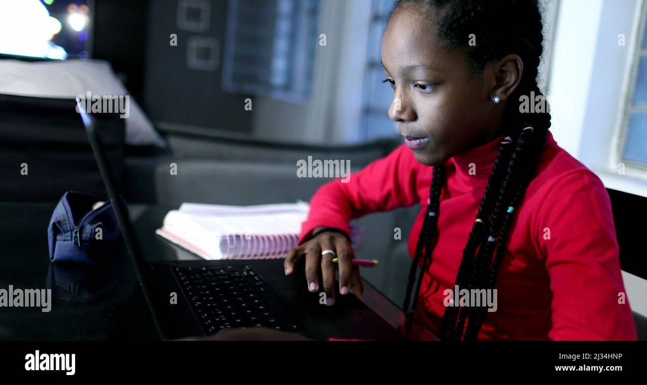 Candid black girl studying at night in front of laptop computer Stock ...