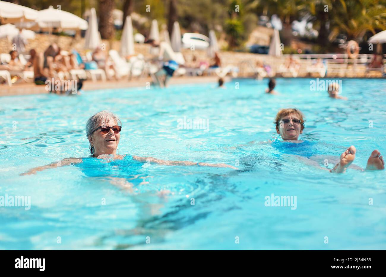 Older woman swimming in pool hi-res stock photography and images - Alamy