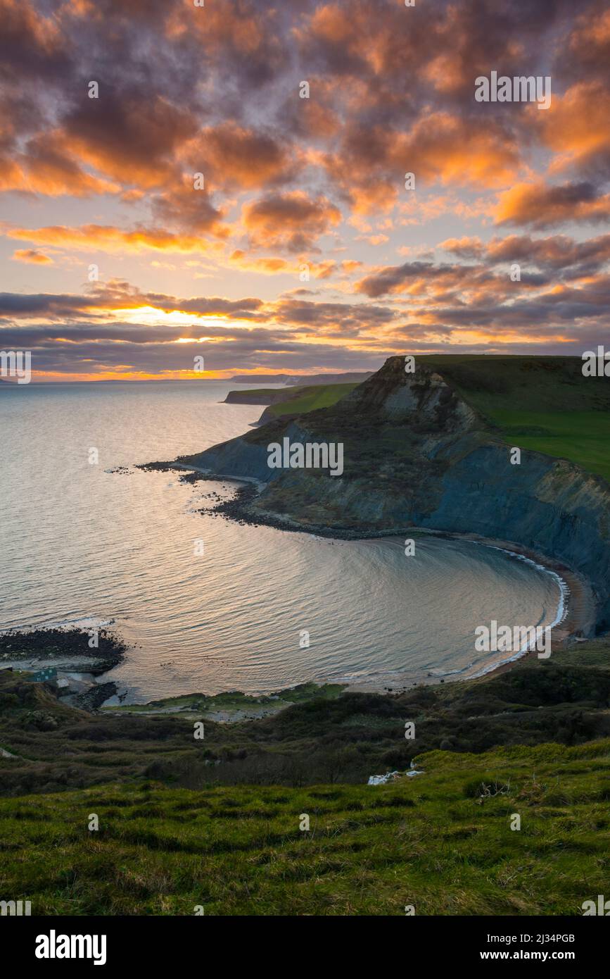 Worth Matravers, Dorset, UK.  5th April 2022.  UK Weather.  A dramatic sunset viewed from the South West coast path on Emmetts Hill looking across Chapmans Pool to the cliffs of Houns Tout on the Dorset Jurassic Coast near Worth Matravers at the end of a windy day with sunny spells.  Picture Credit: Graham Hunt/Alamy Live News Stock Photo