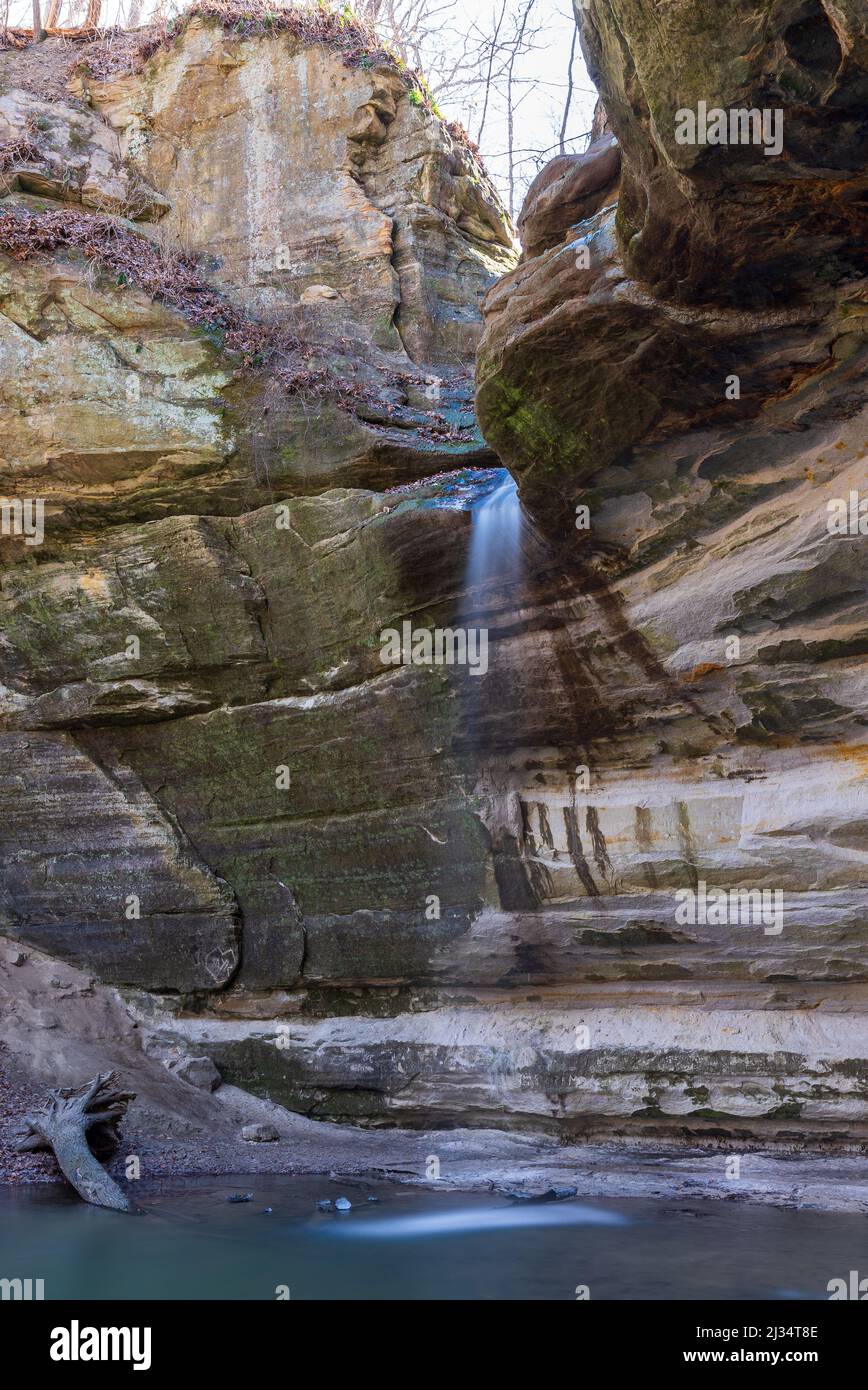 A beautiful scene with massive rocks and water streaming down into the ...