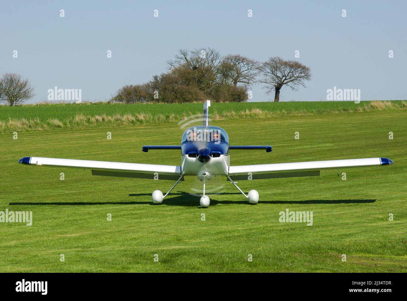 Van's RV-9A light aircraft plane G-GNRV taxiing on the grass airstrip for the air race at Great Oakley, UK. Rural airfield among farmland in Essex Stock Photo