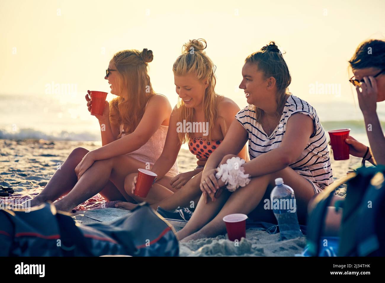 Good times and tan lines. Shot of young female best friends hanging out at the beach. Stock Photo