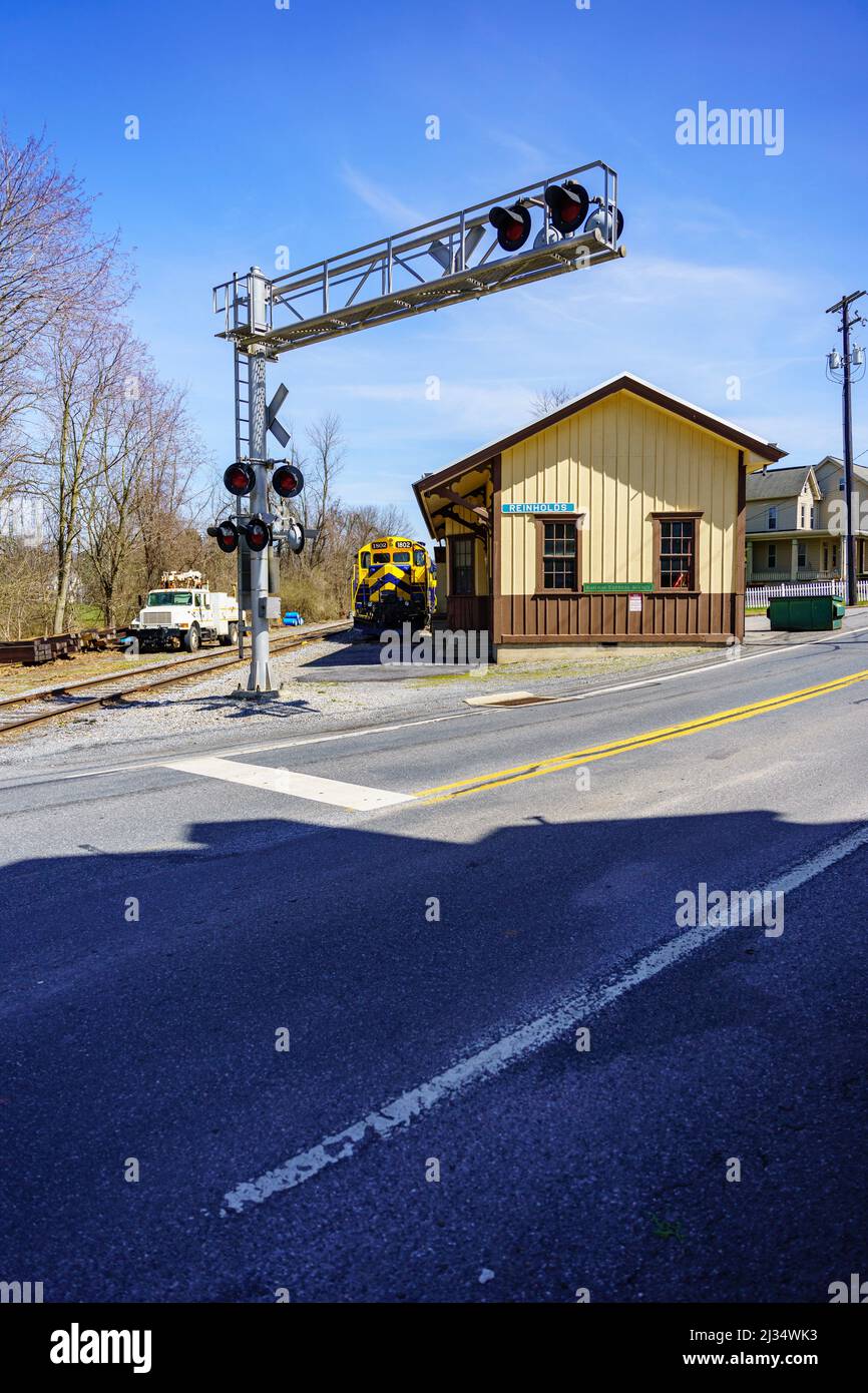 Reinholds, PA, USA - April 2, 2022: The railroad track crossing at the Reinholds train station in rural Lancaster County, Pennsylvania. Stock Photo