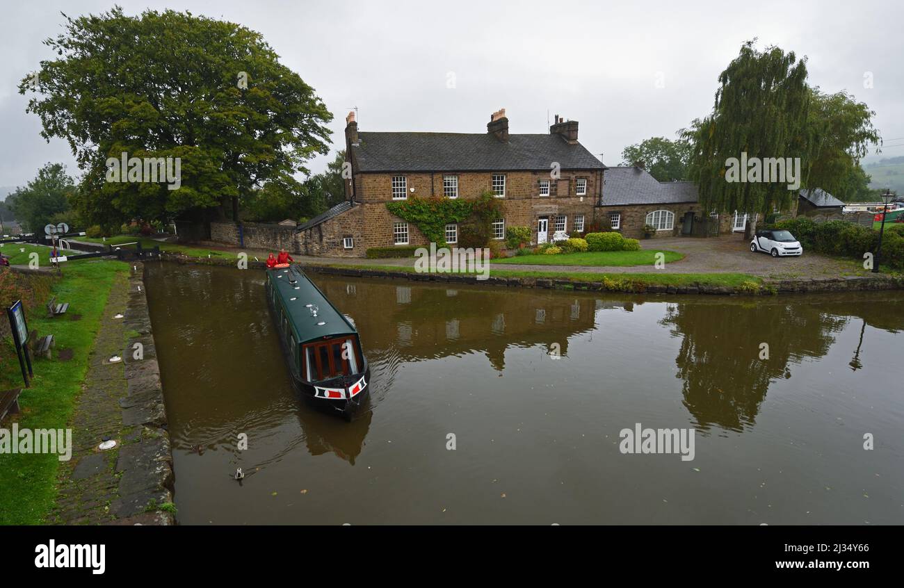 Narrow boat at the top of Marple Lock Flight  - Marple Junction where the Macclesfield Canal meets the Peak  Forest Canal. Stock Photo