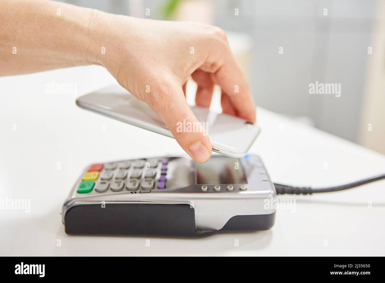 Contactless payment with a smartphone at the NFC card terminal as a retail service Stock Photo