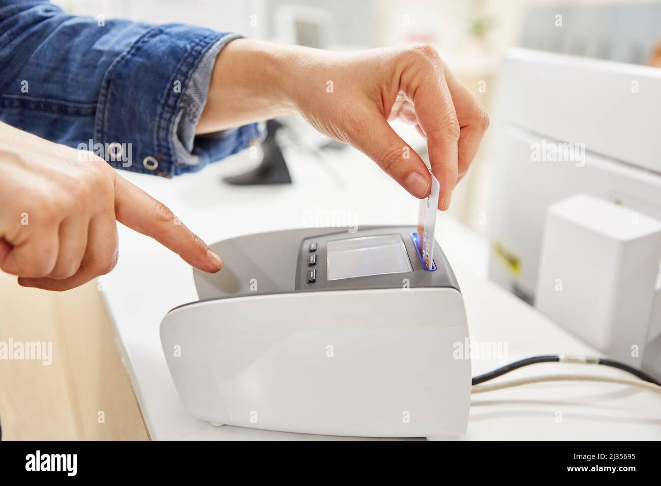 Customer pays for purchase with a credit card at the card terminal in a ...