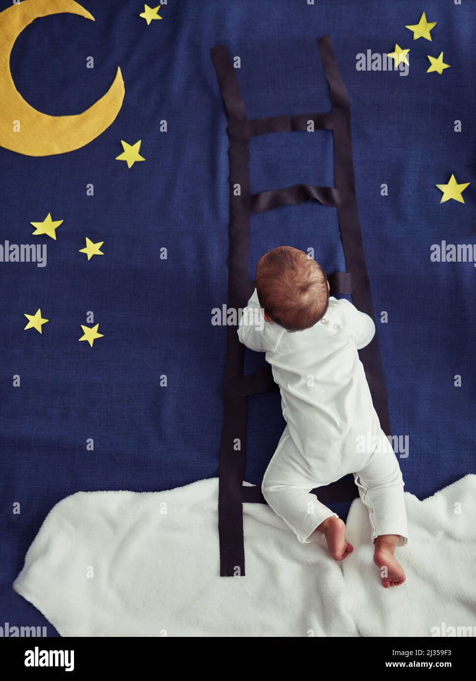 Dream chaser. Concept shot of an adorable baby boy climbing a ladder