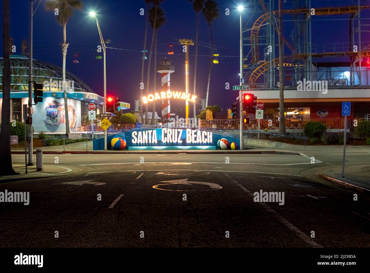 SANTA CRUZ, CA-MAR 31, 2022: Night view of the Santa Cruz Beach Boardwalk, seen from the front entry with its bright neon sign. The vintage seaside am Stock Photo