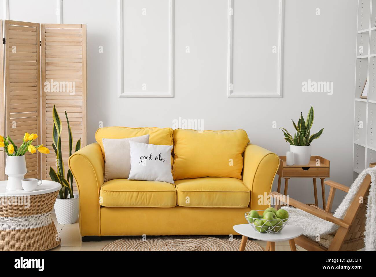 Interior of modern living room with yellow sofa and tables Stock Photo ...