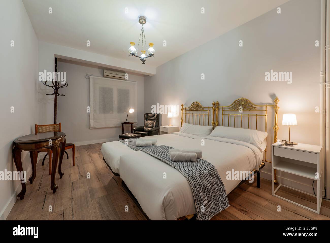 Bedroom with a large vintage double bed with gold metallic headboards