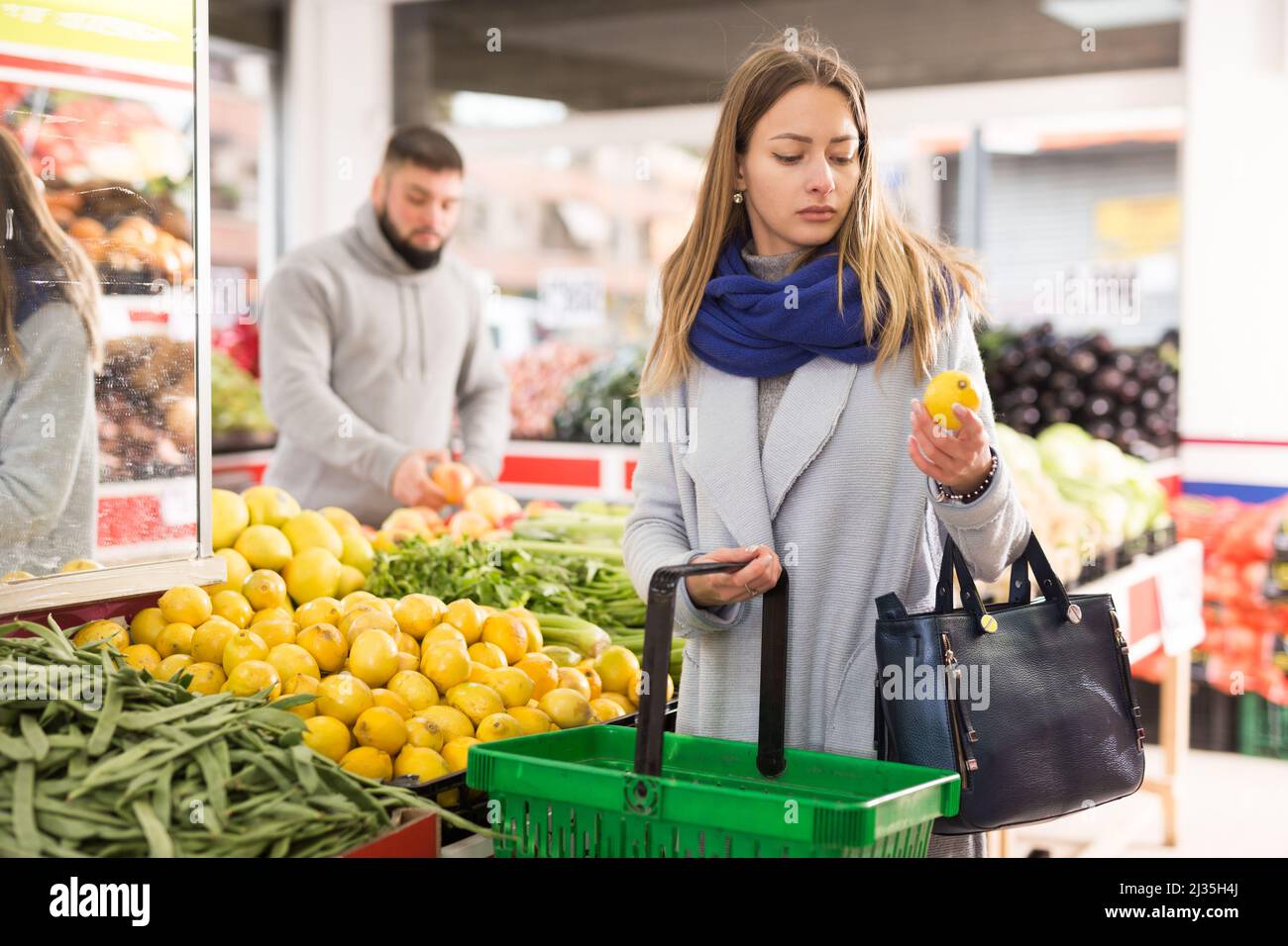 Customer buying lemon at supermarket Stock Photo Alamy